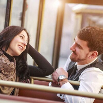 man chatting with a woman he met on public transportation
